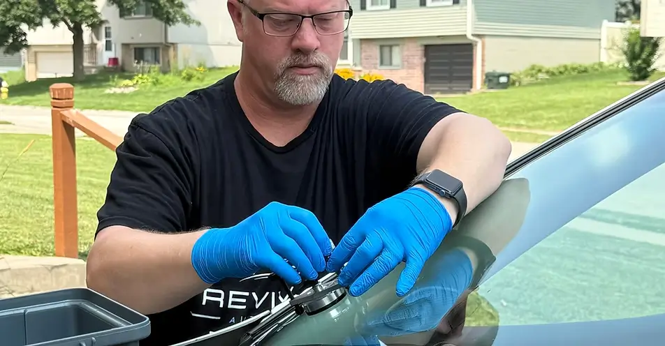 Justin Alloman, owner and operator at Revival Auto Glass hard at work.