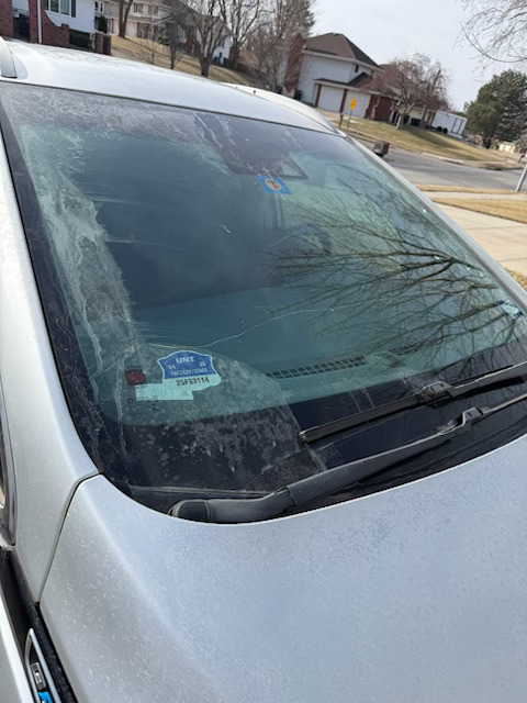 A broken and shattered windshield