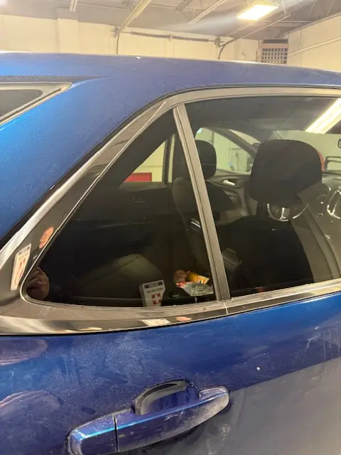 A brand new car door glass being placed and fixed in Omaha.